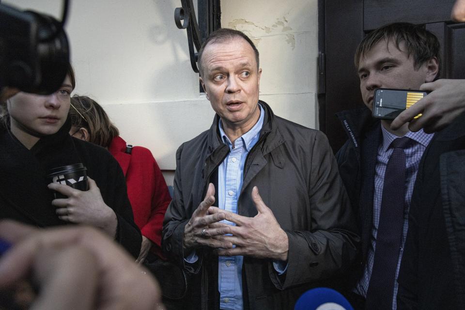 FILE - Russian lawyer Ivan Pavlov, center, is surrounded by journalists after he leaves a court in Moscow, Russia, on Friday, April 30, 2021. Pavlov, who defended former journalist Ivan Safronov on treason charges, left Russia later that year after authorities opened a criminal investigation against him for speaking out about the case. (AP Photo, File)