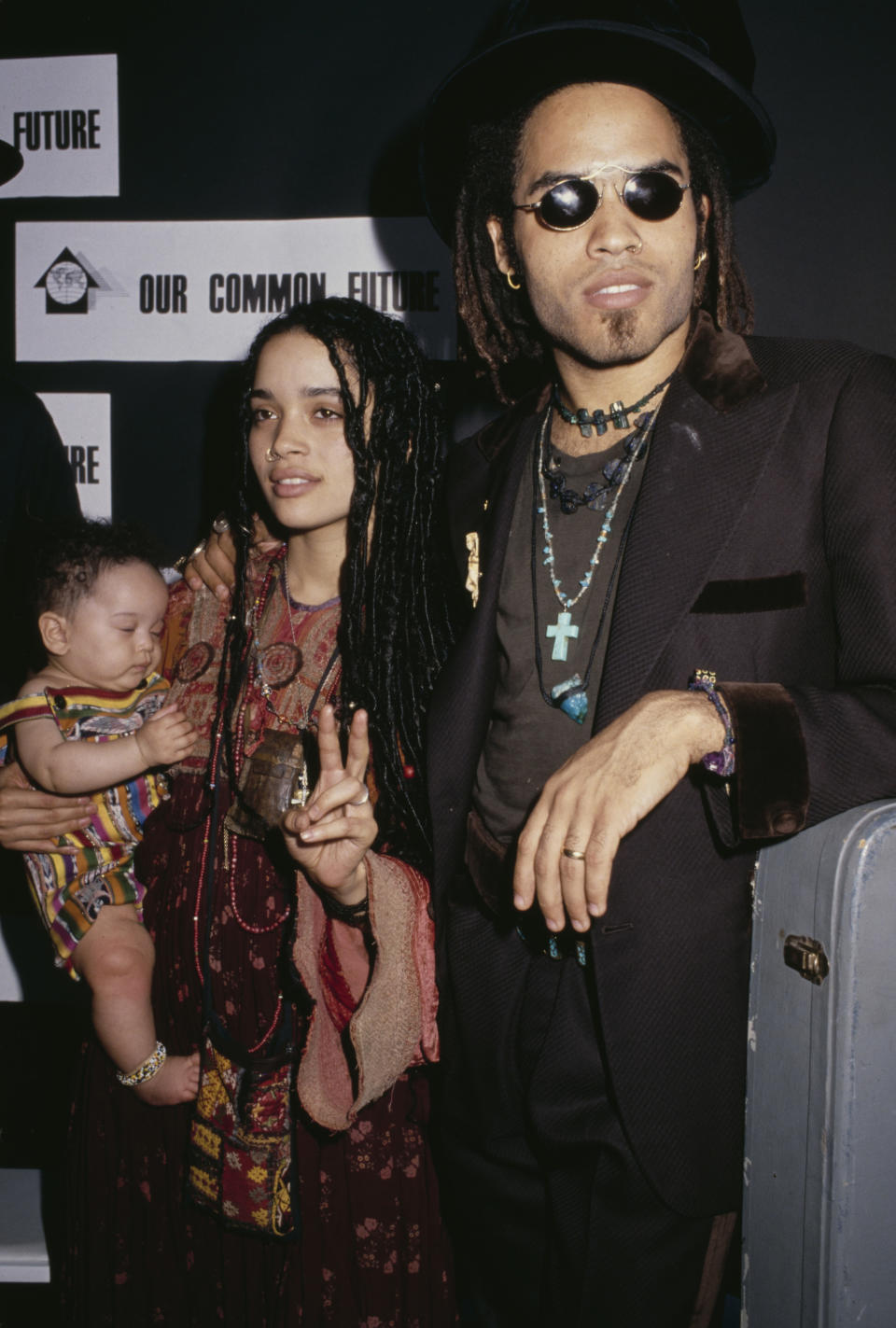 Lenny Kravitz with Lisa Bonet, who is holding a sleeping baby