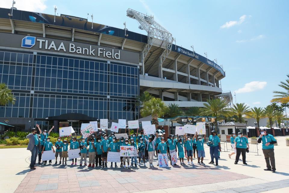 Third grade students from Long Branch Elementary School taking part in the Jaguars Goalsetter program wait for the arrival of Jaguars first round draft pick Trevor Lawrence to arrive at TIAA Bank Field Friday. The Jacksonville Jaguars' first-round draft pick Trevor Lawrence and his wife Marissa Mowry arrived at TIAA Bank Field in Jacksonville, Florida about noon Friday, April 30, 2021. The couple was greeted by team owner Shad Khan and 35 third-grade students from Long Branch Elementary School.