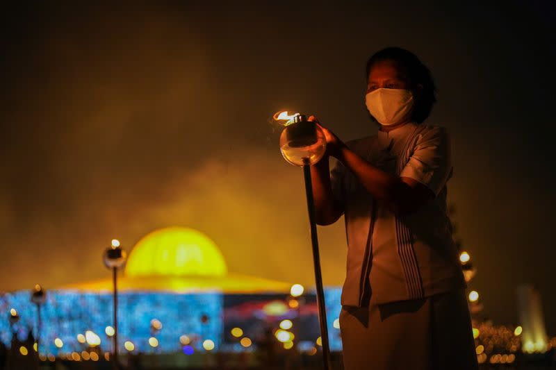 Buddhist devotees gather via Zoom application to commemorate Makha Bucha day in Thailand