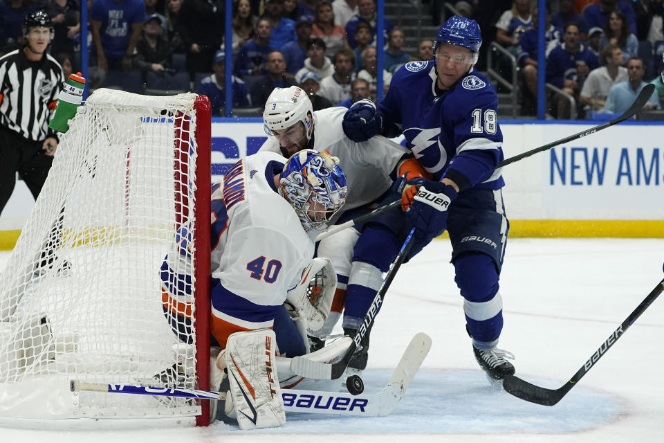 New York Islanders goaltender Semyon Varlamov (40) makes a save on a shot by Tampa Bay Lightning left wing Ondrej Palat (18) during the second period in Game 2 of an NHL hockey Stanley Cup semifinal playoff series Tuesday, June 15, 2021, in Tampa, Fla. (AP Photo/Chris O'Meara)