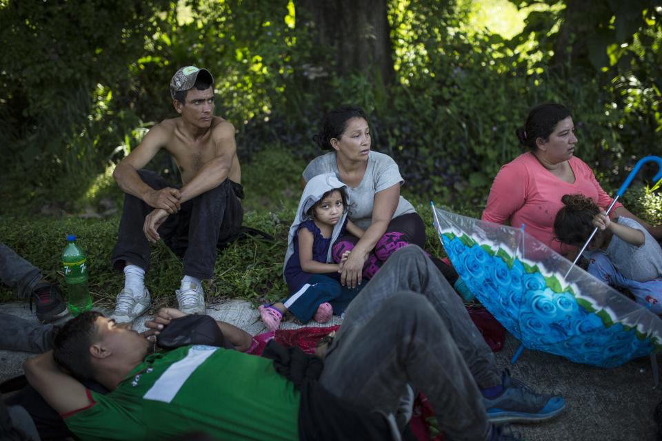 Honduran migrants take a break from walking in Ciudad Hidalgo, Mexico, Tuesday, Oct. 30, 2018. The migrants are part of a second caravan of more than 1,000 that forced its way across the river from Guatemala. Some have begun arriving in the southern Mexico city of Tapachula. (AP Photo/Rodrigo Abd)