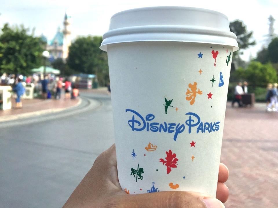 Disney parks coffee cup against the backdrop of Main Street