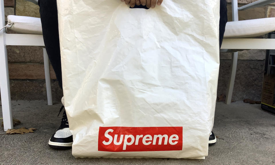 The Supreme logo appears on a plastic shopping bag in Fort Lee, N.J., Monday, Nov. 9, 2020. VF Corp., the owner of The North Face, Vans and Timberland brands, is buying privately held streetwear company Supreme as it looks to grow its online and direct-to-consumer business. (AP Photo/Pablo Salinas)