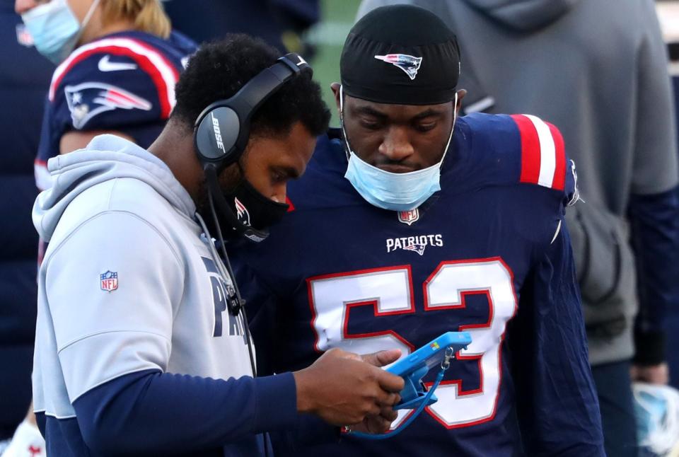 FOXBOROUGH, MASSACHUSETTS - NOVEMBER 29: Josh Uche #53 of the New England Patriots talks with inside linebackers coach Jerod Mayo during the game against the Arizona Cardinals at Gillette Stadium on November 29, 2020 in Foxborough, Massachusetts. (Photo by Maddie Meyer/Getty Images)
