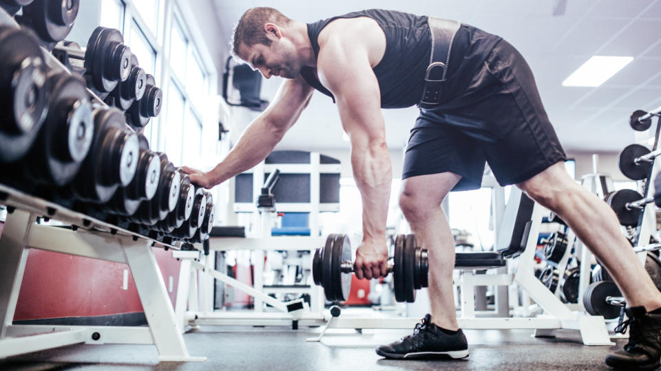 A man performing a single-arm bent-over dumbbell row