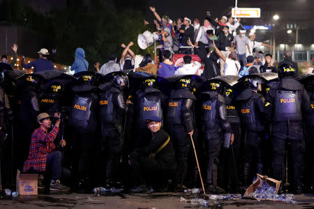 Riot police officers guard during a riot near the Election Supervisory Agency (Bawaslu) headquarters in Jakarta, Indonesia, May 22, 2019. REUTERS/Willy Kurniawan