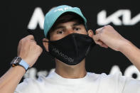Spain's Rafael Nadal removes his mask for a press conference ahead of the Australian Open tennis championships in Melbourne, Australia, Saturday, Jan. 15, 2022. (AP Photo/Simon Baker)
