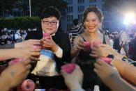 Taiwanese same-sex couples cheer with supporters at their wedding party in Taipei, Taiwan, Saturday, May 25, 2019. Taiwan became the first place in Asia to allow same-sex marriage last week. Hundreds of same-sex couples in Taiwan rushed to get married Friday, the first day a landmark decision that legalized same-sex marriage took effect. (AP Photo/Chiang Ying-ying)