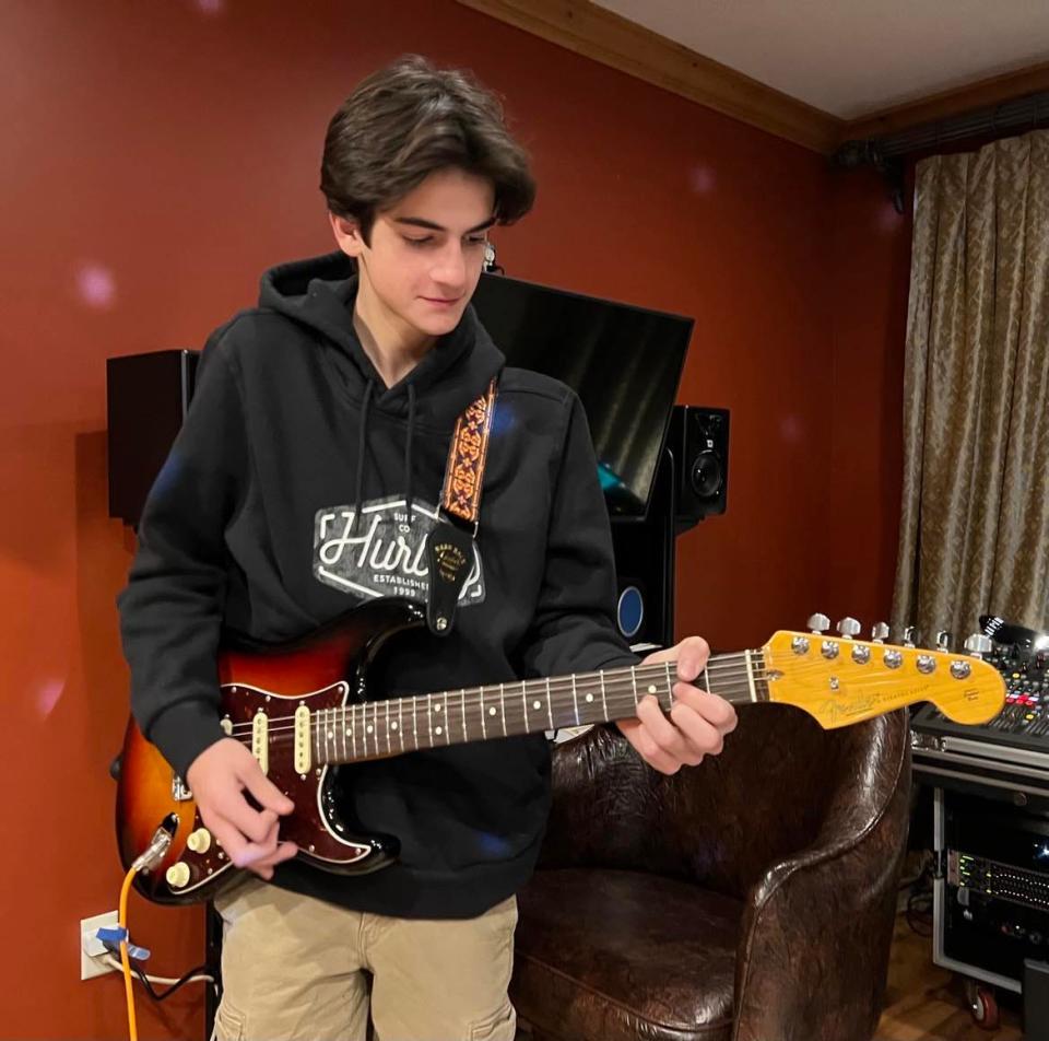 Harrison Kefalas plays guitar during a rehearsal with his brother and sister in the pop rock band COMPASS. The Jackson Township-based band will perform on Feb. 3 in the 27th annual Tri-C High School Rock Off at the Rock & Roll Hall of Fame in Cleveland.