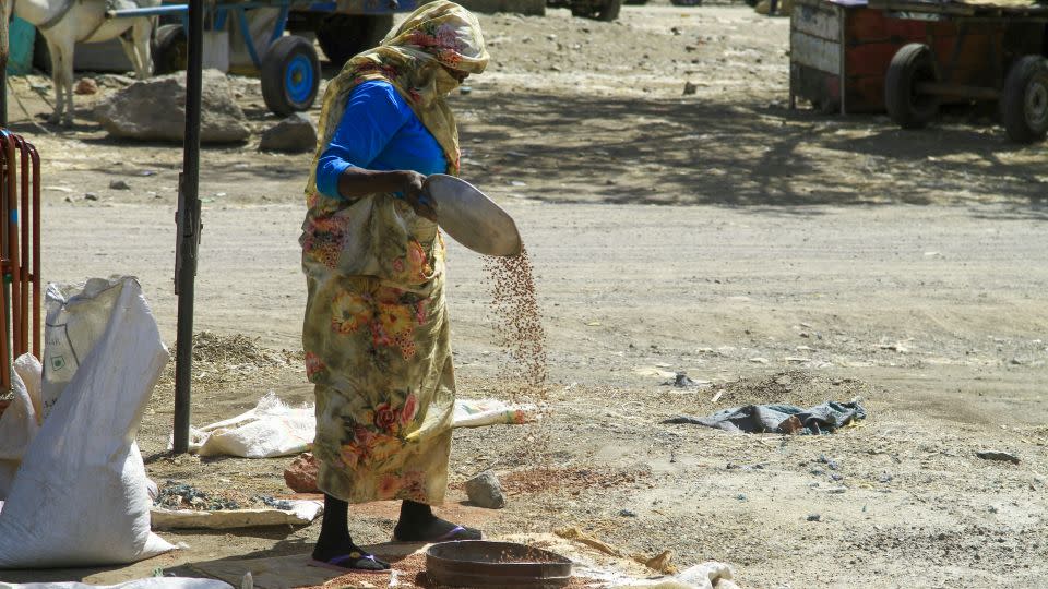 A woman sorts grains at a market in Gedaref, eastern Sudan, on February 22, 2024. Nearly a year into a war that has sent Sudan to the verge of collapse, the vast majority of its people are going hungry, the UN's World Food Programme says. - EBRAHIM HAMID/AFP/AFP via Getty Images