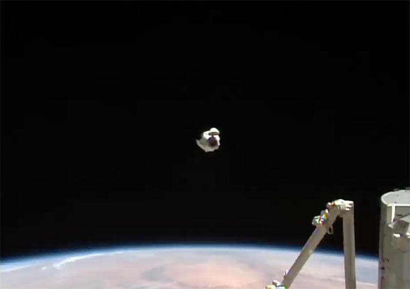 The Crew Dragon backed away to a point about 180 feet in front of the station, as seen here, before climbing up to a point directly above the Harmony module's space-facing port and moving back in for docking. / Credit: NASA TV