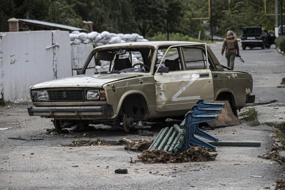 KUPIANSK, KHARKIV, UKRAINE - SEPTEMBER 20: A wheelless car lying in the middle of a street in the city after it was regained from Russian forces, in Kupiansk, Kharkiv, Ukraine on September 20, 2022. (Photo by Metin Aktas/Anadolu Agency via Getty Images)