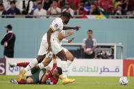 Portugal's Cristiano Ronaldo falls after fighting for the ball during the World Cup group H soccer match between Portugal and Ghana, at the Stadium 974 in Doha, Qatar, Thursday, Nov. 24, 2022. (AP Photo/Ariel Schalit)