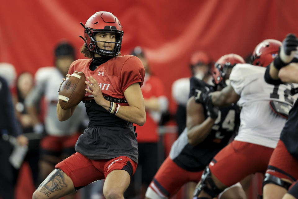 FILE - Cincinnati quarterback Evan Prater drops back to pass during an NCAA football intrasquad scrimmage, Saturday, April 9, 2022, in Cincinnati. Prater, who threw just 11 passes in mop-up duty last year, is competing against Ben Bryant, who spent three years at Cincinnati before escaping Ridder's long shadow and transferring to Eastern Michigan last season. (AP Photo/Aaron Doster, File)