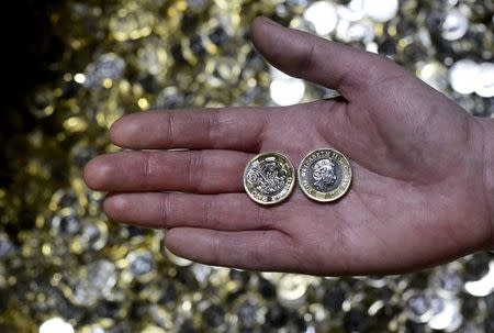 New one pound coins are displayed The Royal Mint, in Llantrisant, Wales, Britain, January 25, 2017. Picture taken January 25, 2017. REUTERS/Rebecca Naden