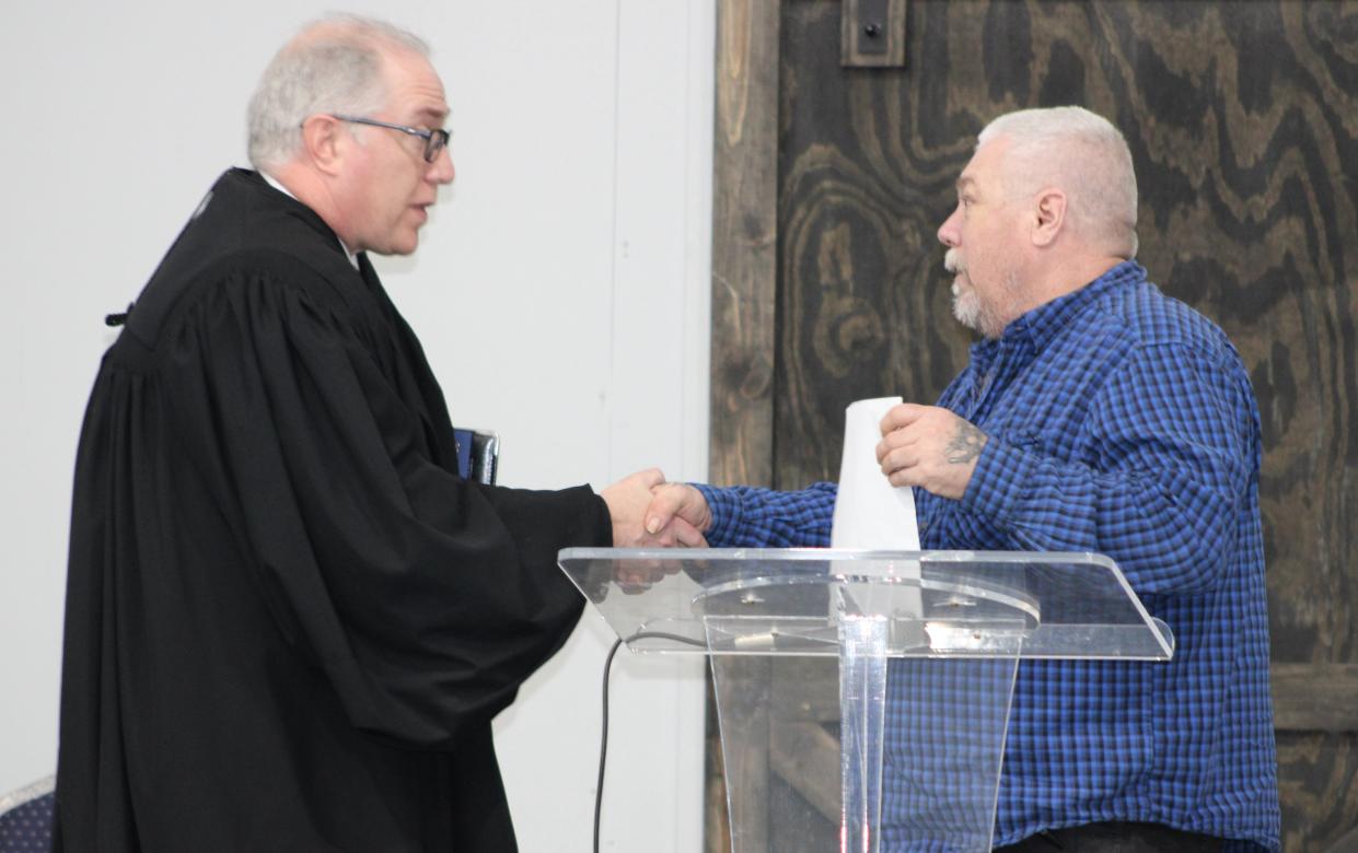 Marion County Common Pleas Court Judge Warren T. Edwards, left, congratulates F.I.R.S.T. Court graduate William Harper Jr. during a ceremony held Friday, April 21, 2023, at Marion First Church of the Nazarene. Harper shared how the drug court program helped him become sober.
