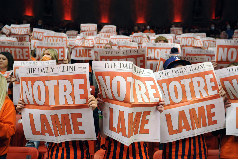 Illinois fans read the Daily Illini student newspaper as the Notre Dame players are introduced before an NCAA college basketball game Monday, Nov. 29, 2021, in Champaign, Ill. (AP Photo/Michael Allio)