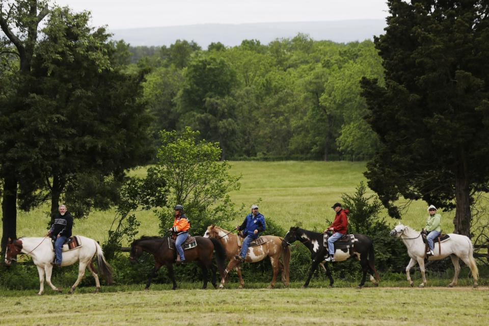 In this Friday, May 24, 2013 photo, mounted visitors tour Gettysburg National Military Park, in Gettysburg, Pa. Tens of thousands of visitors are expected for the 10-day schedule of events that begin June 29 to mark 150th anniversary of the Battle of Gettysburg that took that took place July 1-3, 1863. (AP Photo/Matt Rourke)