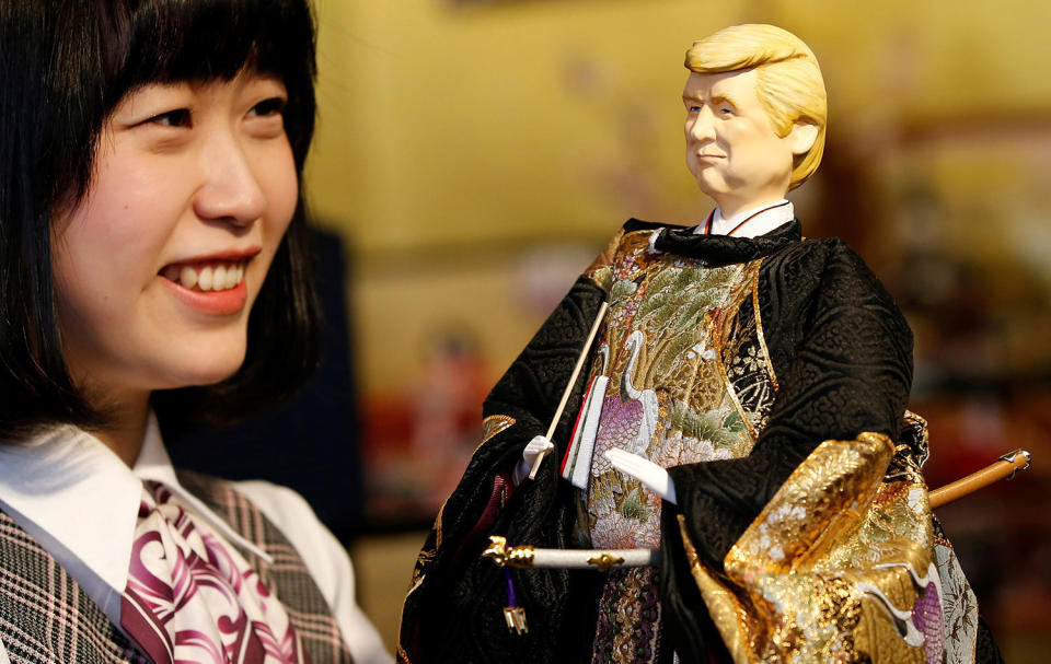 Japanese doll-maker poses with a doll of President Trump