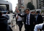 Venezuela's National Assembly President and opposition leader Juan Guaido, who many nations have recognised as the country's rightful interim ruler, gestures as he walks to the National Assembly building in Caracas