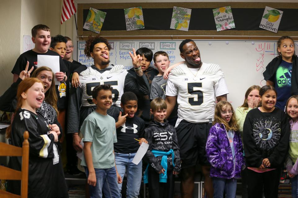 Purdue Boilermaker football freshman offensive lineman Malachi Preciado and defensive end Nic Caraway take a photo with students after Edgelea Elementary School's ILEARN prep rally, on Friday, April 7, 2023, in Lafayette, Ind.