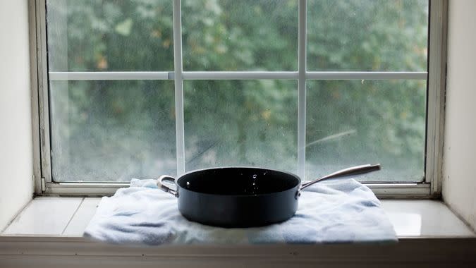 Water dripping from ceiling into pan due to a hurricane; Brooklyn, New York, USA.