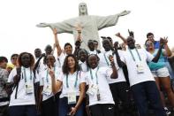 2016 Rio Olympics - Christ the Redeemer - 30/07/2016. Members of the Olympic refugee team including Yusra Mardini from Syria (C) pose in front of Christ the Redeemer. REUTERS/Kai Pfaffenbach