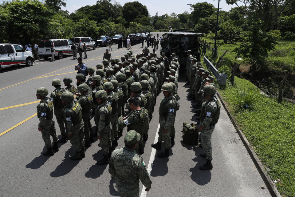 Military Police form up on the highway, in Metapa, Chiapas state Mexico, Wednesday, June 5, 2019. A law enforcement group of police officers, Marines, Military Police and immigration officials arrived at the area to intercept a caravan of migrants that had earlier crossed the Mexico – Guatemala border. (AP Photo/Marco Ugarte)