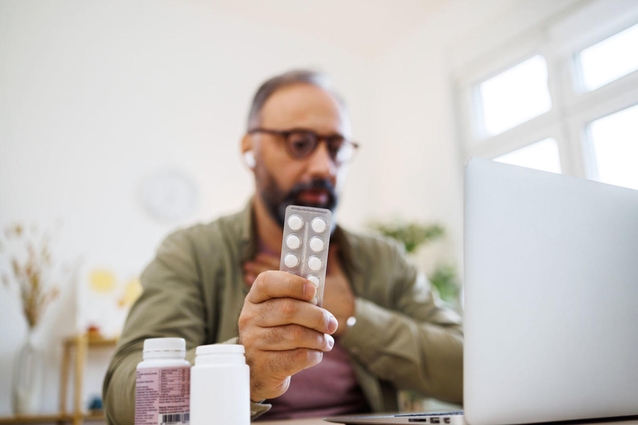 Man consulting his doctor about drug medicine online Getty Images/mixetto