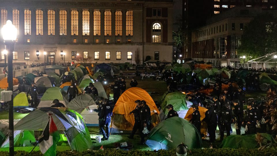 NYPD officers in riot gear enter Columbia University's encampment as they evict a building that had been barricaded by pro-Palestinian student protesters on April 30. - Emily Byrski/AFP/Getty Images