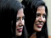 Swini and Srini 28, pose for photographs during an event to attempt to break the world record for the biggest gathering of twins in Colombo