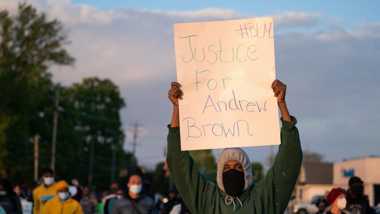 demonstrator holds a sign for Andrew Brown Jr. during a protest march on April 22, 2021 in Elizabeth City, North Carolina. The protest was sparked by the police killing of Brown on April 21.