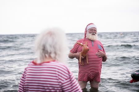 People dressed as Santa Claus bathe in the sea as they take part in the World Santa Claus Congress, an annual event held every summer at the amusement park Dyrehavsbakken, in Copenhagen, Denmark. Scanpix Denmark/Sarah Christine Noergaard/via REUTERS