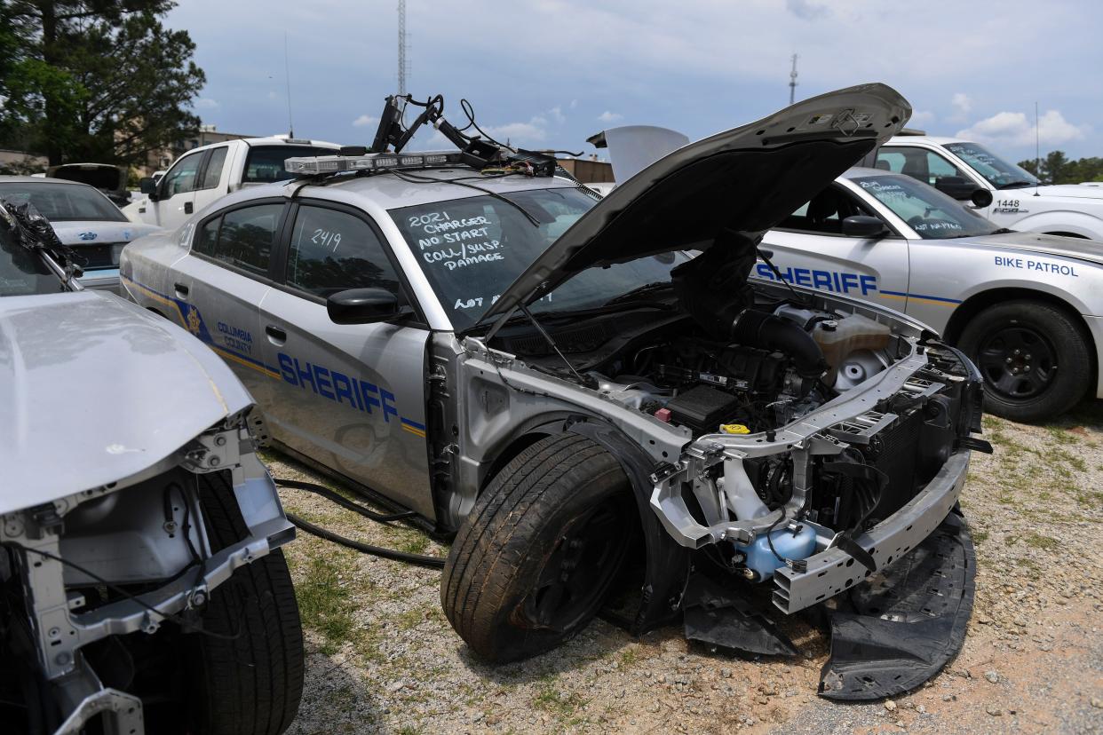 Police cars sits in a lot behind the Columbia County Fleet Services building on Friday, May 3, 2024. These vehicles and more will be auctioned off by the county on May 18th.