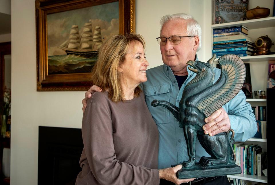 Steve and Kathie Libert hold a sculpture of a griffon in their Charlevoix home. The statue is the French coat of arms symbol for which the ill-fated ship, Le Griffon, was named. The Liberts spent the last 42 years working to solve the mystery of the Griffon, the first full-size ship ever to sail the Great Lakes above Niagara Falls. Steve plans to speak about their quest on May 12 at the Rochester Hills Public Library.