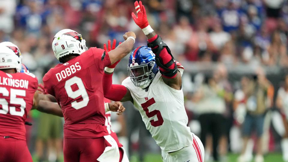 Sep 17, 2023; Glendale, Arizona, USA; Arizona Cardinals quarterback Joshua Dobbs (9) is pressured by New York Giants linebacker Kayvon Thibodeaux (5) as he throws during the second half at State Farm Stadium.