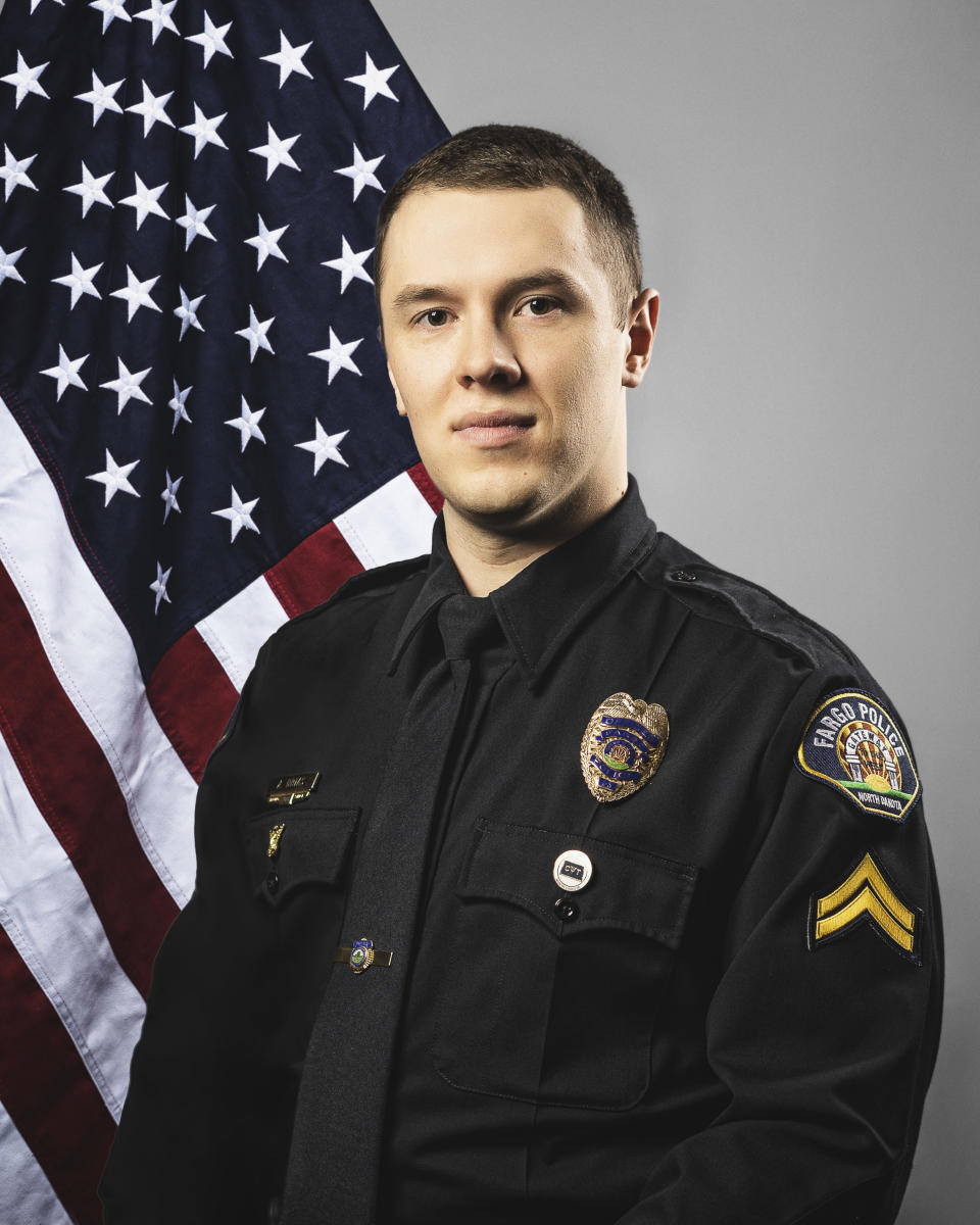 This photo provided by The City of Fargo, N.D., on Saturday, July 15, 2023 shows police officer Andrew Dotas. On Saturday, Fargo's police chief said a gunman opened fire on police and firefighters as they responded to a traffic crash in North Dakota. One officer was killed and Dotas and another were wounded before a fourth officer killed him. (The City of Fargo via AP)