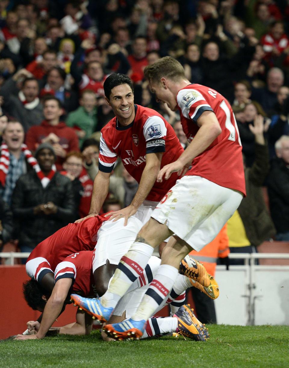 Arsenal's Cazorla celebrates with team-mates after scoring a goal against Liverpool during their English Premier League soccer match in London