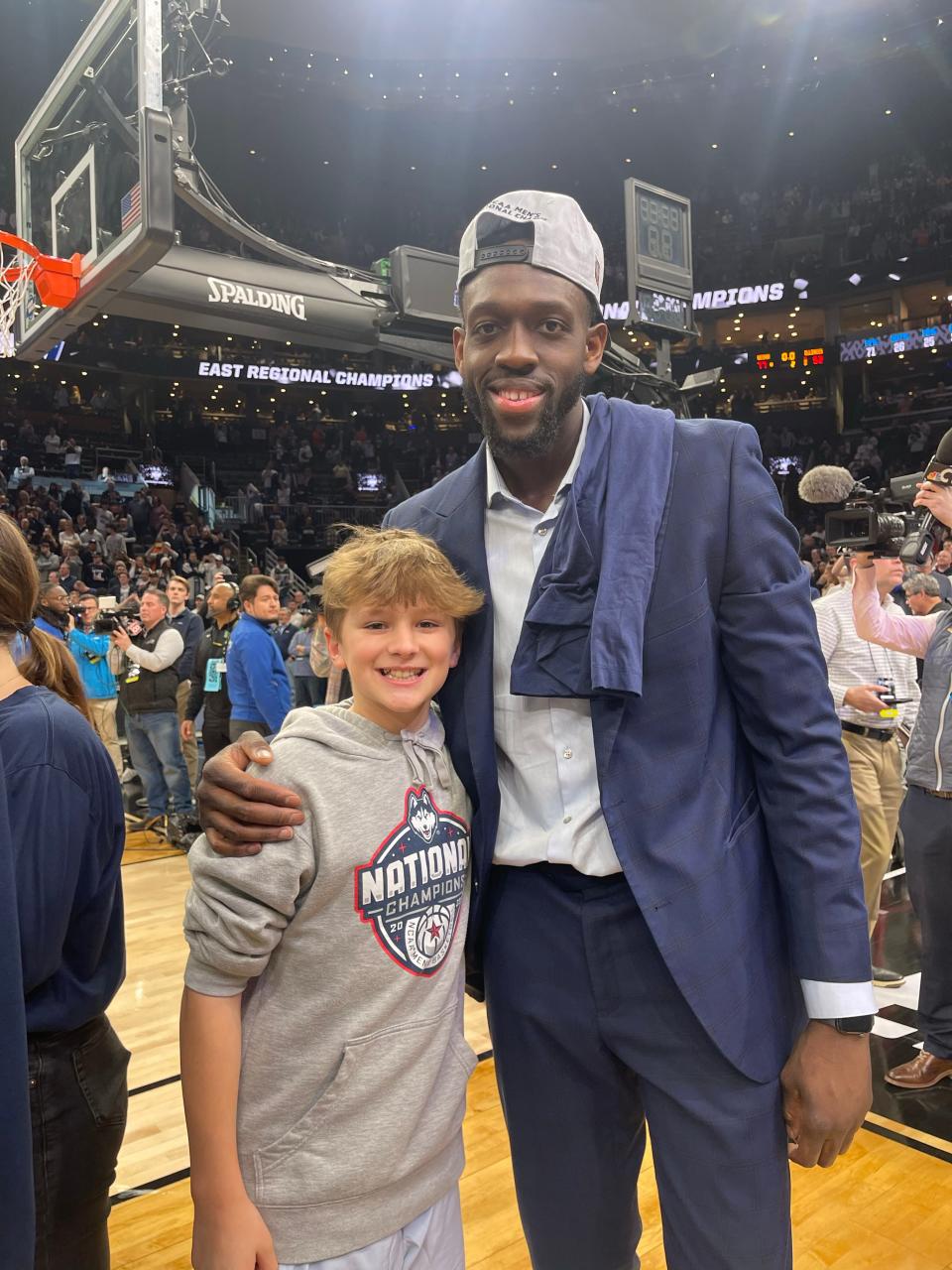 Rylan Ellingwood and UConn director of player development Mamadou Diarra celebrate after the team's win over No. 3 Illinois in the Elite 8 last week.
