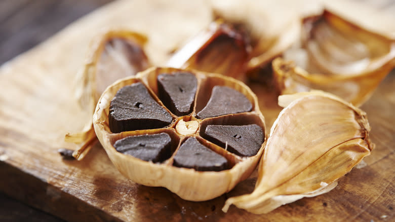 Black garlic on cutting board 