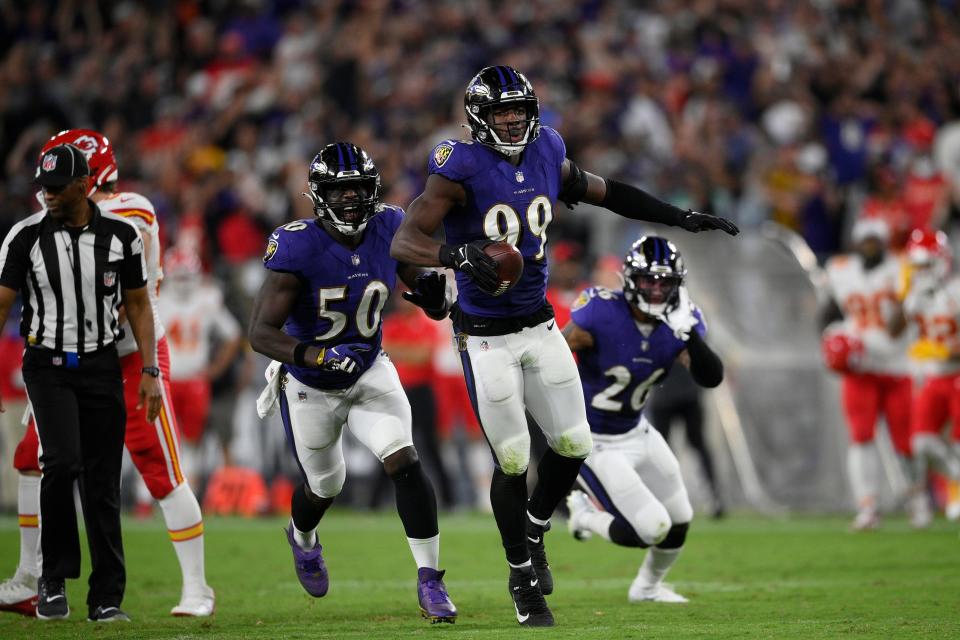 Odafe Oweh (99) celebrates his fumble recovery against the Chiefs.