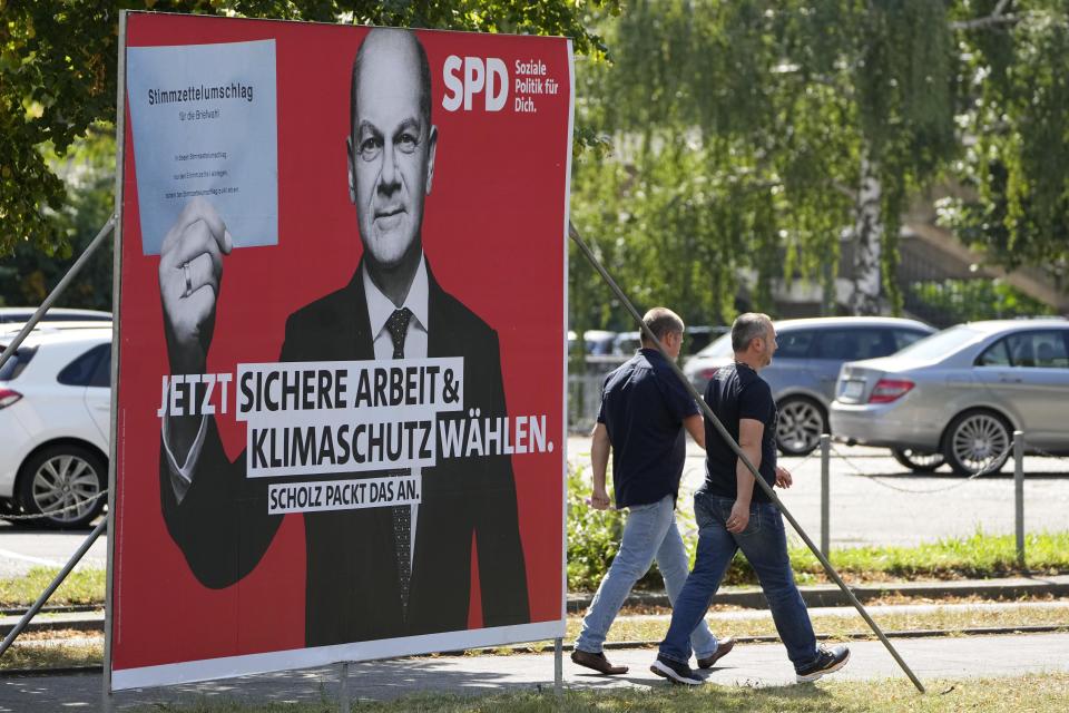 An election poster for the German Social Democrats, SPD, shows top candidate Olaf Scholz at a street in Duesseldorf, Germany, Wednesday, Aug. 25, 2021. A large chunk of the German electorate remains undecided going into an election that will determine who succeeds Angela Merkel as chancellor after 16 years in power. Recent surveys show that support for German political parties has flattened out, with none forecast to receive more than a quarter of the vote. (AP Photo/Martin Meissner)