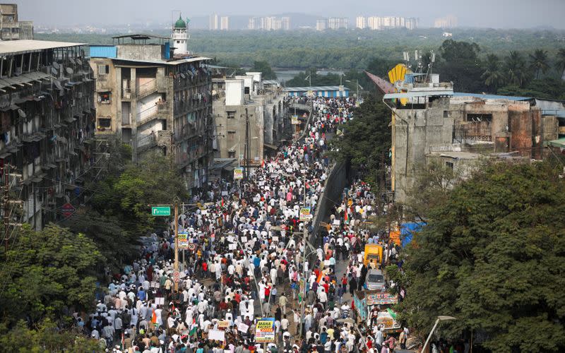 Demonstrators walk during a protest march against a new citizenship law, on the outskirts of Mumbai