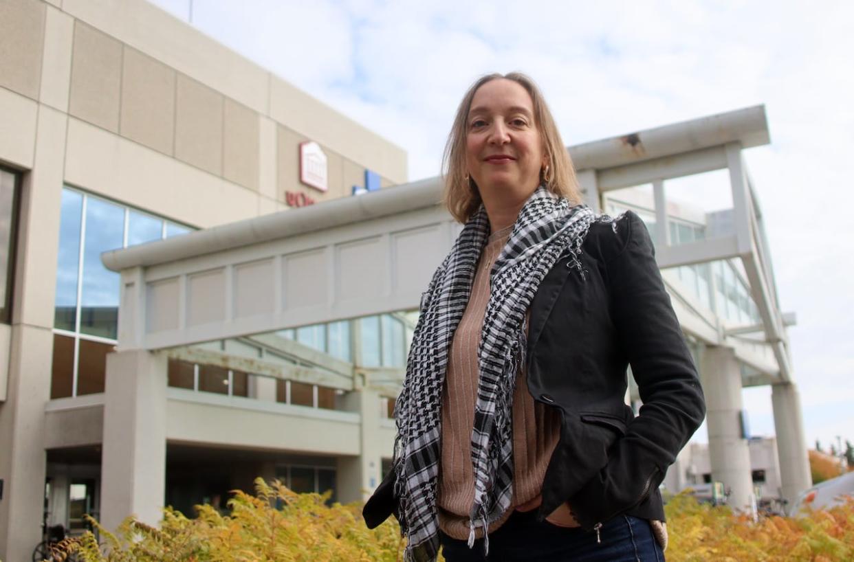 Dr. Angela Crawley stands outside The Ottawa Hospital's General campus in October. She and her team have been following hundreds of people over several years through the Stop the Spread COVID-19 project, and they're now worried federal funding for the immunology research could soon run out. (Trevor Pritchard/CBC - image credit)