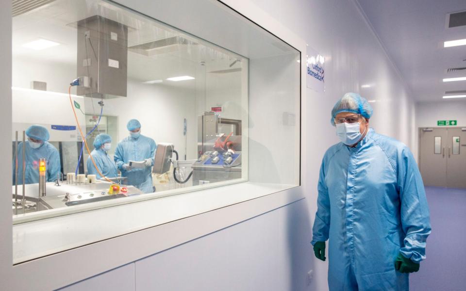 Mr Johnson at a viewing window where technicians are manufacturing the Astro Zeneca Covid-19 vaccine -  Heathcliff O'Malley
