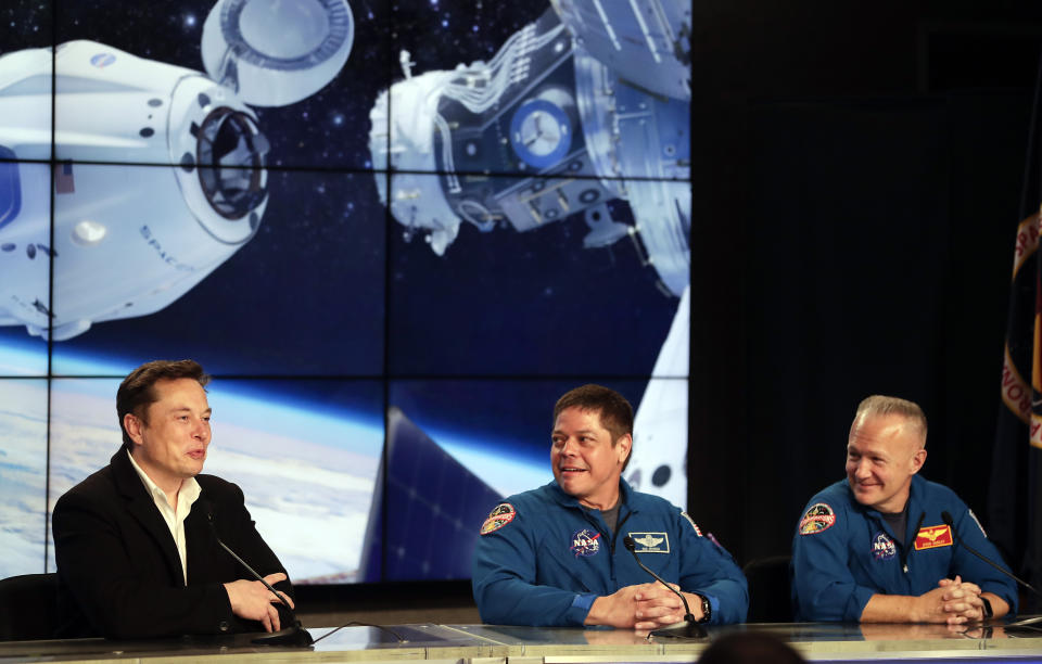 FILE - In this Saturday, March 2, 2019 file photo, Elon Musk, left, CEO of SpaceX, speaks accompanied by NASA astronauts Bob Behnken, center, and Doug Hurley during a news conference after the SpaceX Falcon 9 Demo-1 launch at the Kennedy Space Center in Cape Canaveral, Fla. (AP Photo/John Raoux)