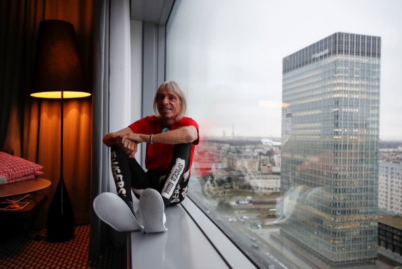 French climber Alain Robert, also known as "Spiderman" poses for a picture in his hotel before an interview with Reuters, near Paris