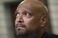 U.S. Capitol Police Sgt. Harry Dunn watches a video of rioters during the House select committee hearing on the Jan. 6 attack on Capitol Hill in Washington, Tuesday, July 27, 2021. (Brendan Smialowski/Pool via AP)