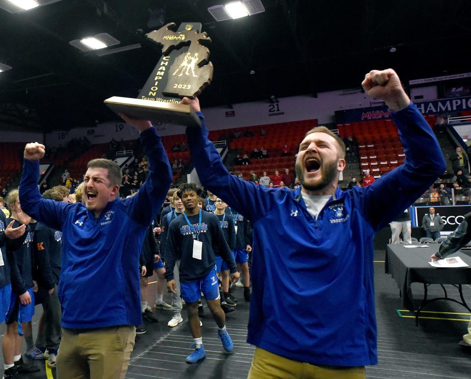Dundee head coaches Garrett Stevens and Nate Hall raised the yell out and raise the Division 3 Team Championship trophy after beating Whitehall at the Wings Event Center in Kalamazoo Saturday, February 25, 2023.